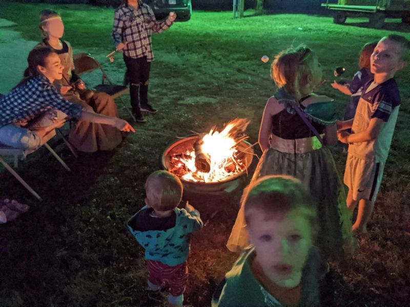 Church families around an evening bonfire