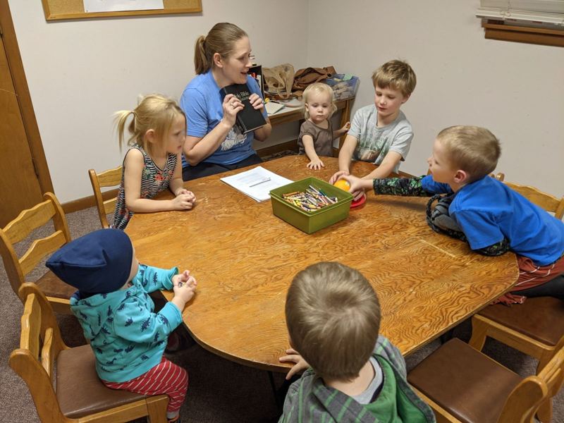 Kids Club gathered around a table on a Wednesday night