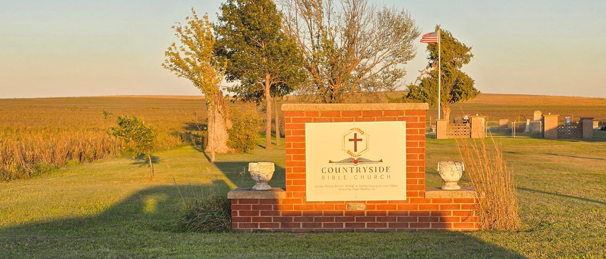 The Countryside Bible Church sign at sunset, with the Kansas prairie behind it